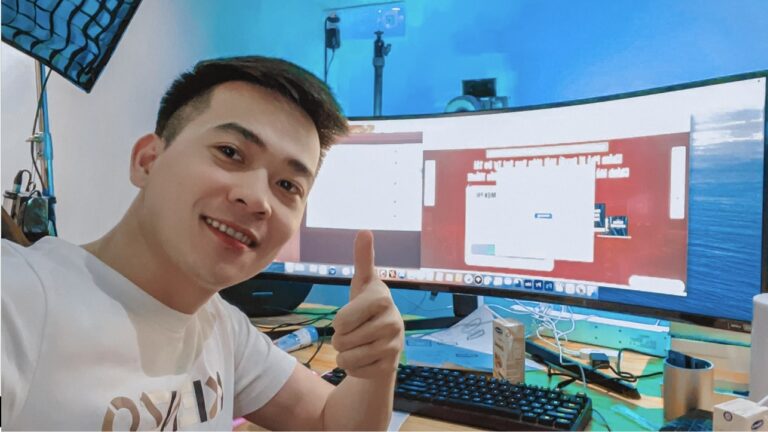 Vietnamese YouTuber gives thumbs up at his editing desk