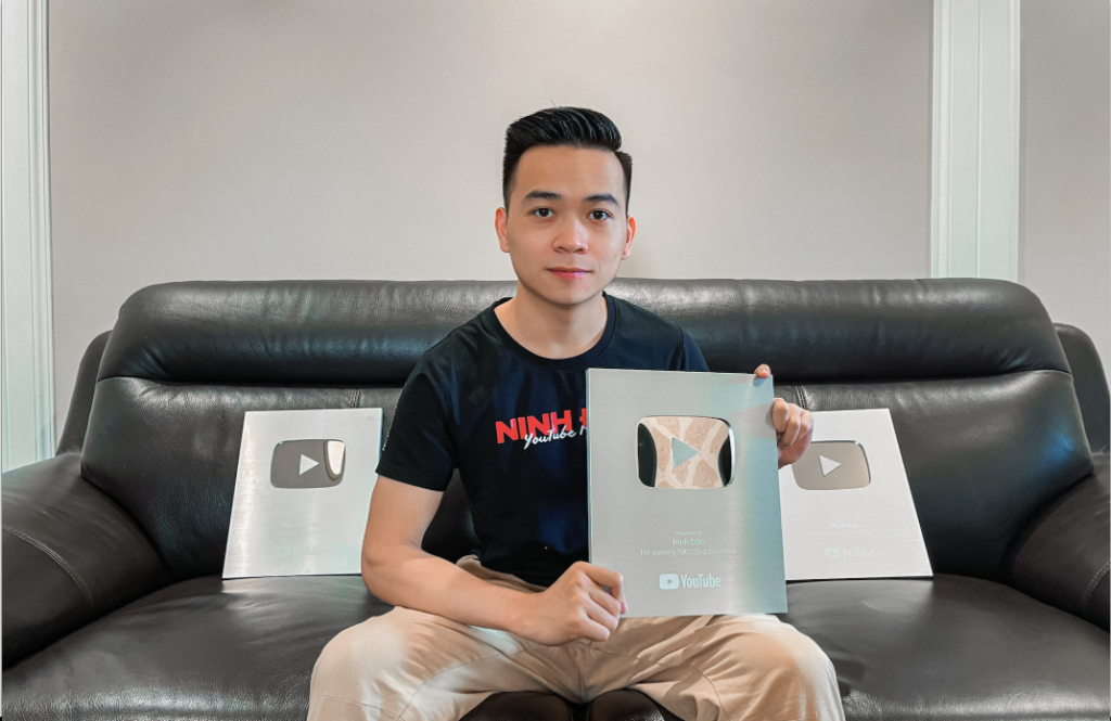 Vietnamese YouTuber holds YouTube award plaques after $20 start