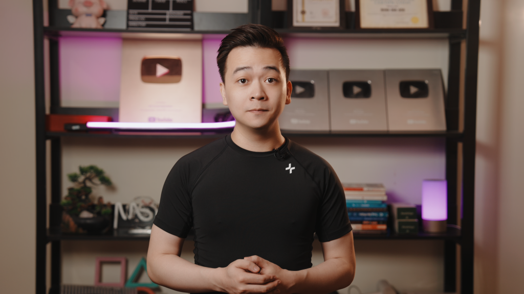 Vietnamese YouTuber Talks in Front of Play Buttons and Studio