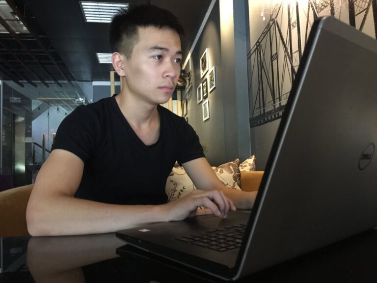 Young Vietnamese man building a YouTube business on a laptop